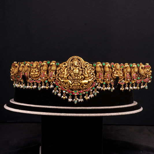 Vamika vaddanam, gold plated 92.5 silver vaddanam featuring ruby and emerald stones with beautiful temple designs