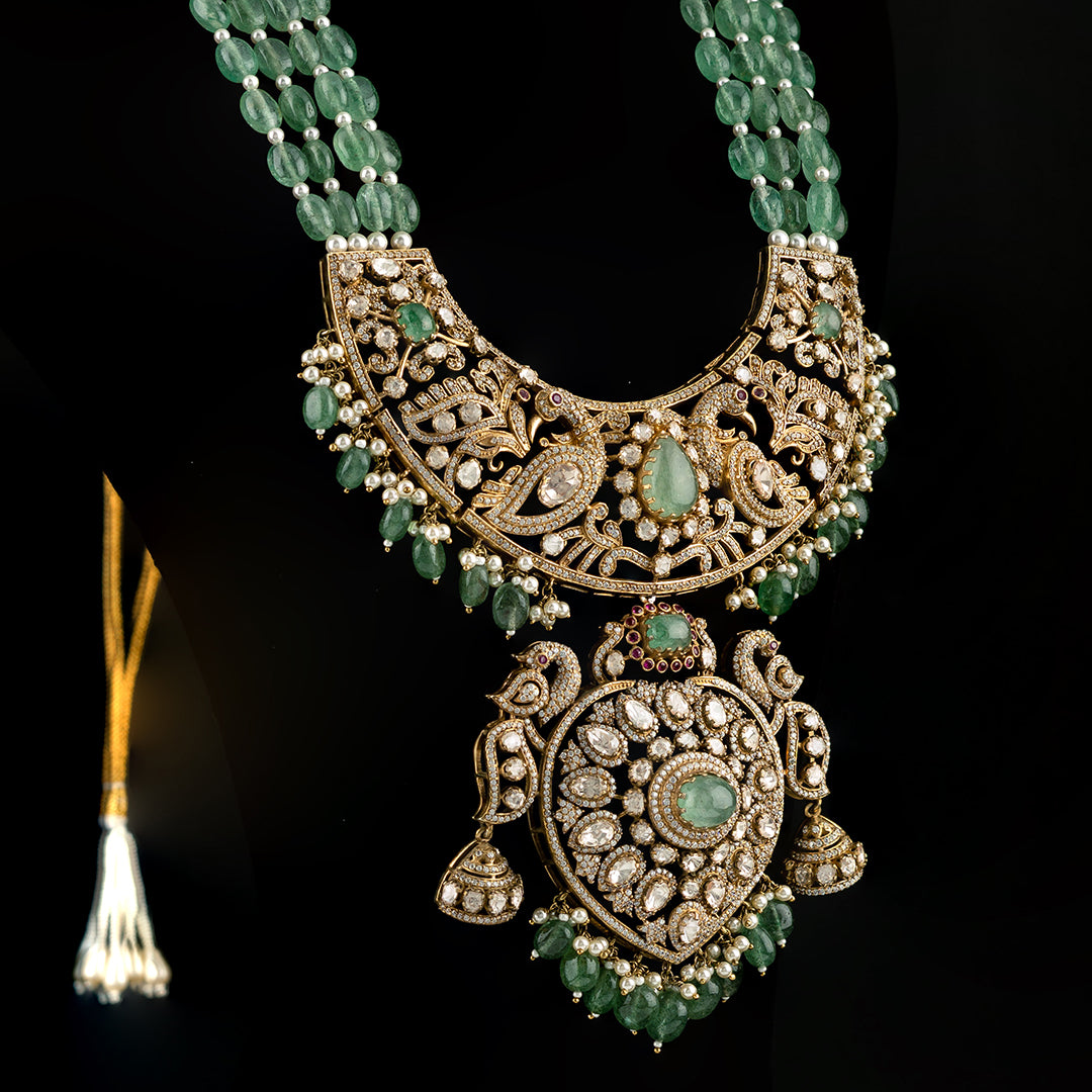 Aniya Victorian gold plated haram, crafted with high-quality gold-plated 92.5 silver featuring emerald, moissanite, CZ stones with tourmaline and seed pearls.