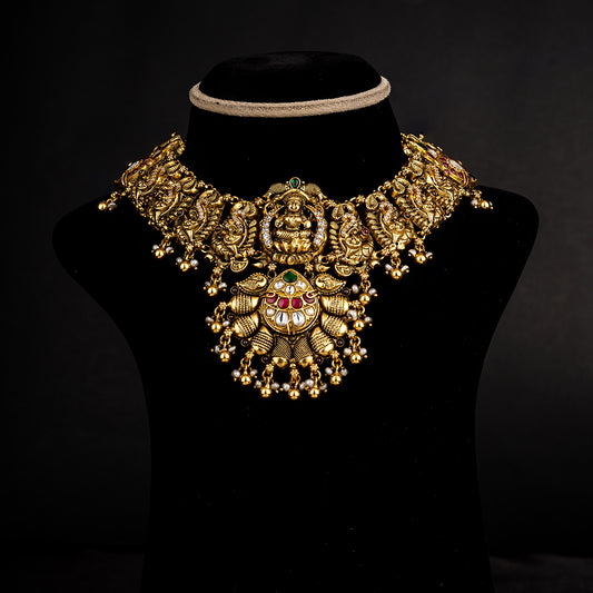 Nainika Nakshi Necklace, Gold plated premium 92.5 silver necklace featuring emeralds, cubic zirconia, ruby, and moissanite stones